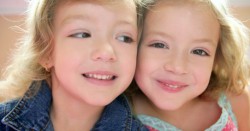 Two little beautiful toddler twin sisters
